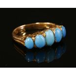 A five stone turquoise carved head style ring,