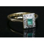 An emerald and diamond rectangular cluster ring