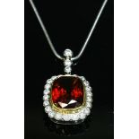 An 18ct yellow and white gold garnet and diamond cluster pendant,