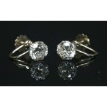 A pair of single stone diamond stud earrings