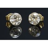 A pair of single stone diamond stud earrings