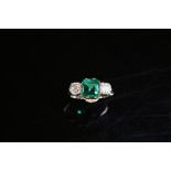 A Colombian emerald and diamond three stone ring,