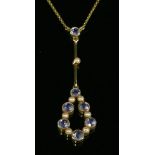 An Edwardian gold sapphire and split pearl Edna May style pendant, c.1910,