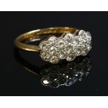 A diamond set triple daisy cluster ring