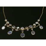 An Edwardian gold moonstone and sapphire swag and fringe necklace,