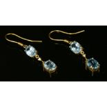 A pair of 18ct gold, two stone blue topaz and diamond drop earrings