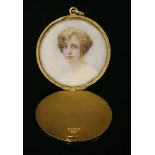 An Edwardian flat section gold hinged locket