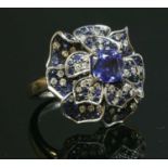 An 18ct white gold tanzanite, sapphire and diamond flower head cocktail ring,