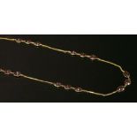 A garnet set chain with sets of oval and pearl shaped mixed cut garnets