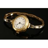 A ladies' 15ct gold left handed mechanical bracelet watch