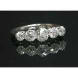 A graduated five stone diamond ring with old European cut diamonds