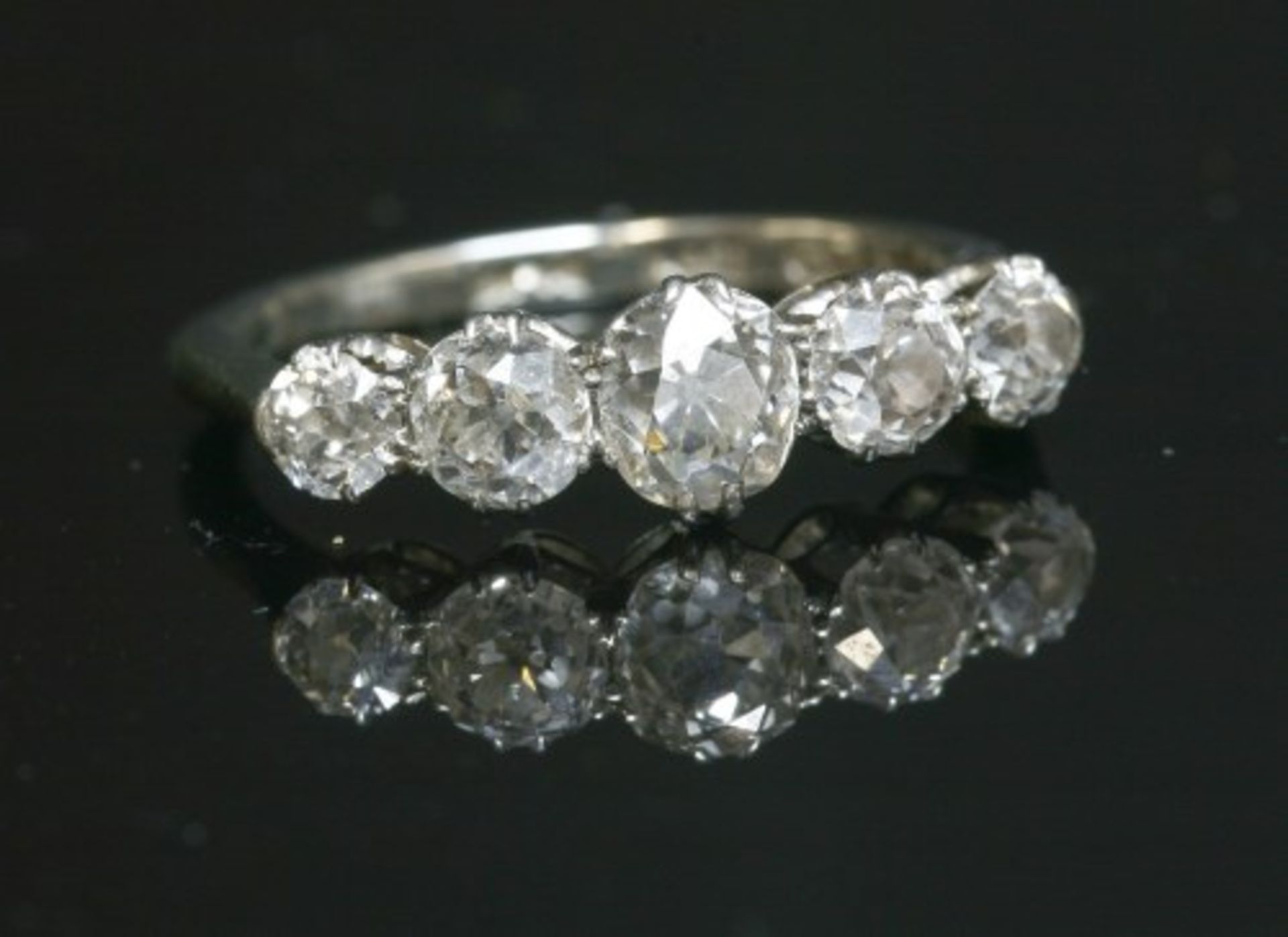 A graduated five stone diamond ring with old European cut diamonds