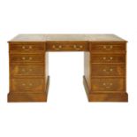 A walnut breakfront pedestal desk