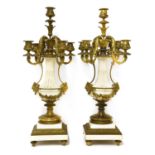 A pair of gilt bronze and white marble five-branch candelabra,