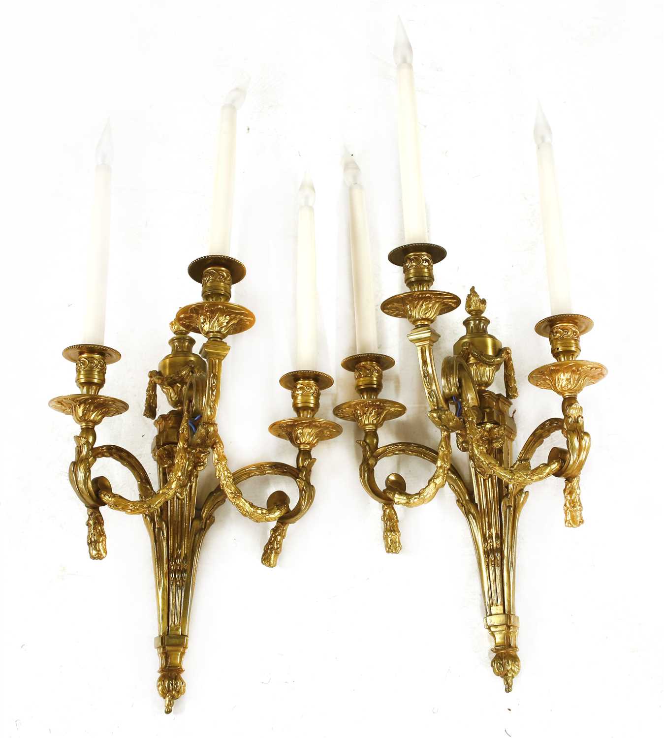 A pair of gilt brass three-branch wall lights,