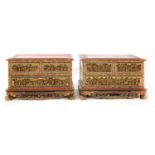 A pair of Chinese red lacquered and gilt low chests,