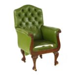 A carved mahogany and green leatherette upholstered library armchair,