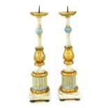 A pair of Italian carved wooden gilt and painted pricket candlesticks,