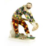 A Meissen figure of a bowing harlequin,