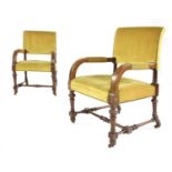 A pair of Victorian walnut framed open armchairs
