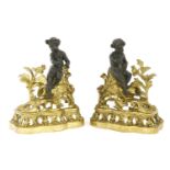 A pair of French bronze and gilt metal chenet