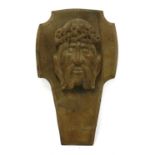 An antique carved oak mask of Christ