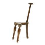 An unusual, primitive, three-legged 'Cockfighting' chair,