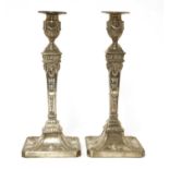 A pair of George lll Adam design silver candlesticks
