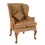 A George III-style wing back armchair,