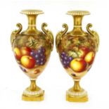 A pair of Royal Worcester urn-shaped vases