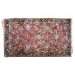 A Persian silk and woollen rug,