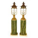 A pair of lamps and columns