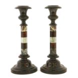A pair of serpentine candlesticks