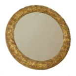 A carved giltwood circular wall mirror,