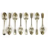 A set of twenty-four Victorian silver fiddle pattern dessert spoons,