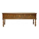 A three-drawer oak dresser base,