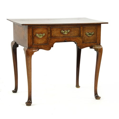 An oak and crossbanded lowboy,