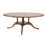 A Regency-style rosewood circular dining table,