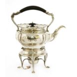 A silver tea kettle on stand