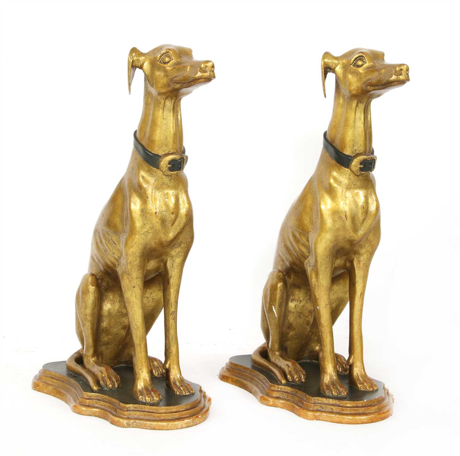 A pair of parcel-gilt seated whippets,