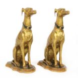 A pair of parcel-gilt seated whippets,