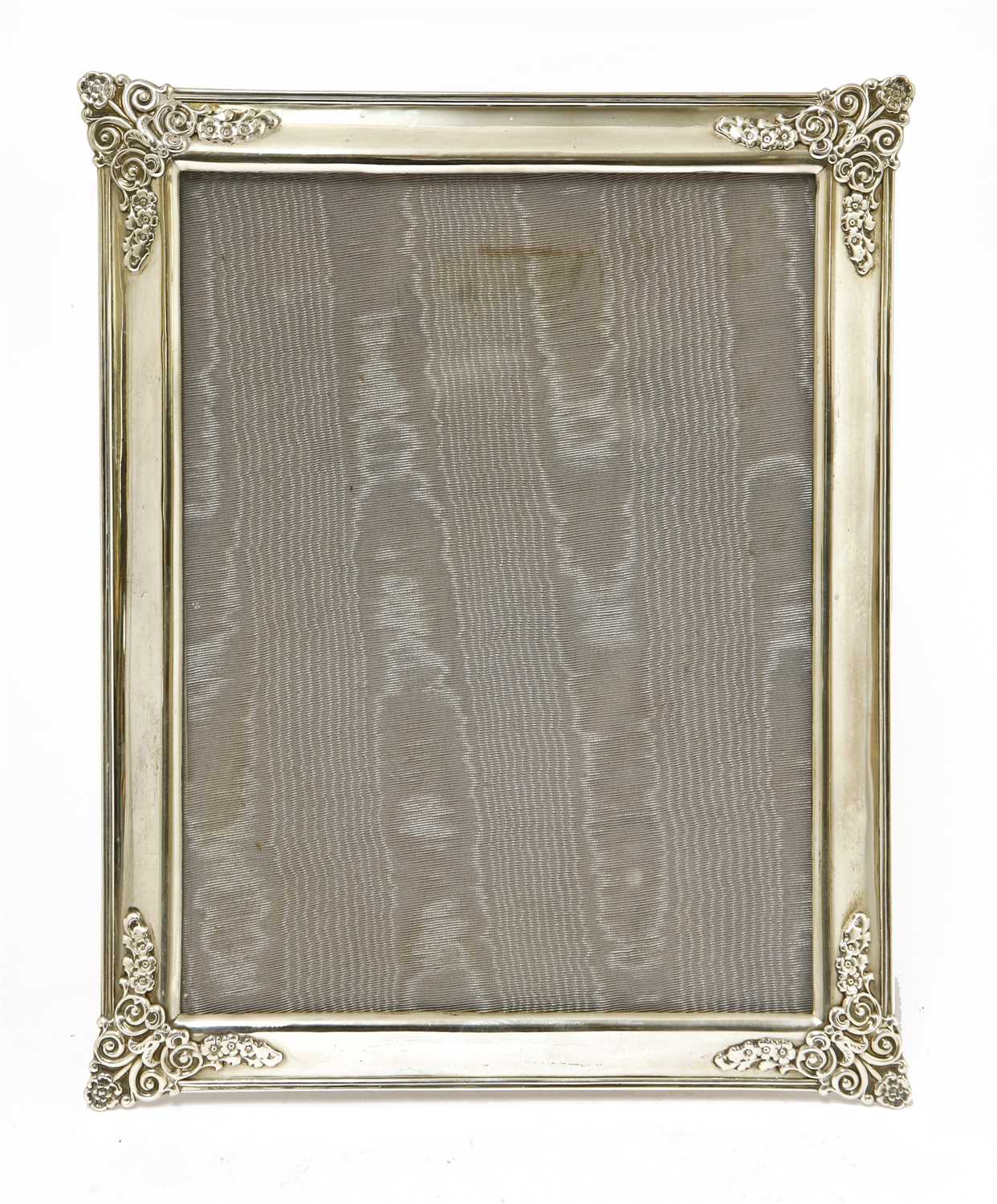 A silver photograph frame and easel stand,