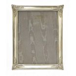 A silver photograph frame and easel stand,
