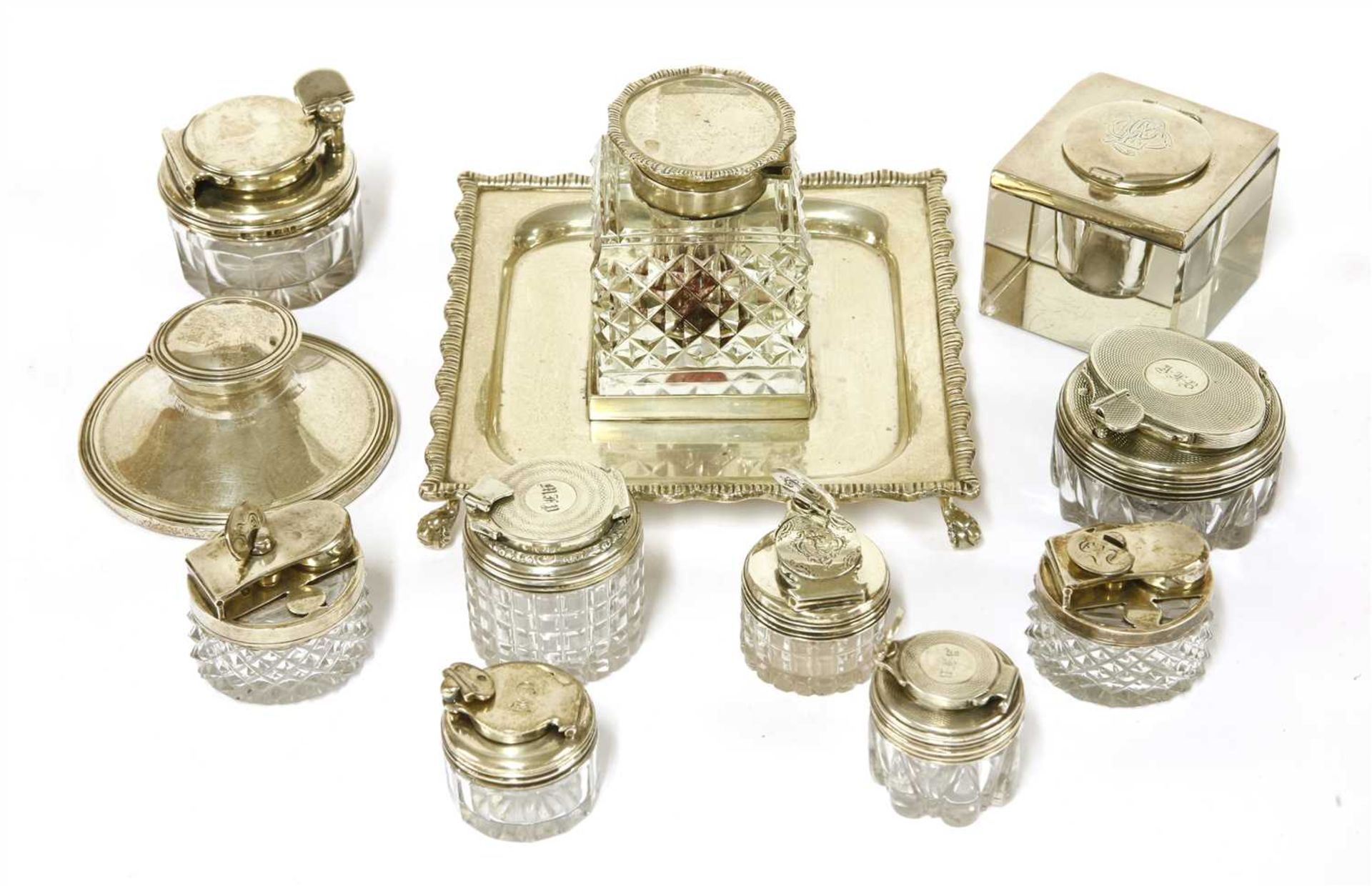 Eleven silver-mounted glass inkwells,