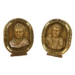 A pair of carved walnut roundels,