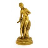 A gilt bronze figure holding a dove,
