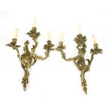 A pair of Louis XV-style gilt bronze three-branch wall lights,