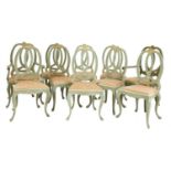 A set of ten French green and cream painted dining chairs,