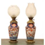 A pair of Imari vase oil lamps,