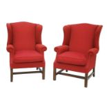 A pair of George III-style wing back armchairs,